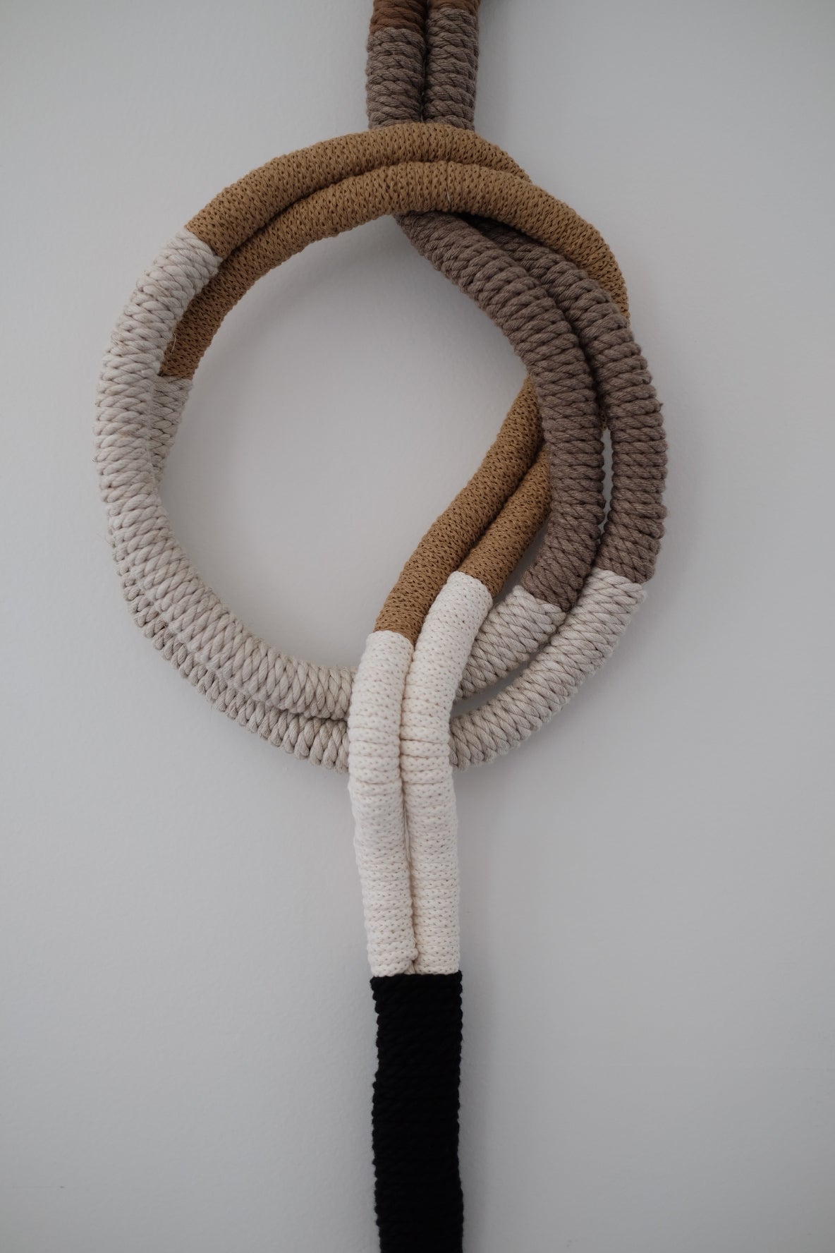 wrapped wall hanging in neutral colors