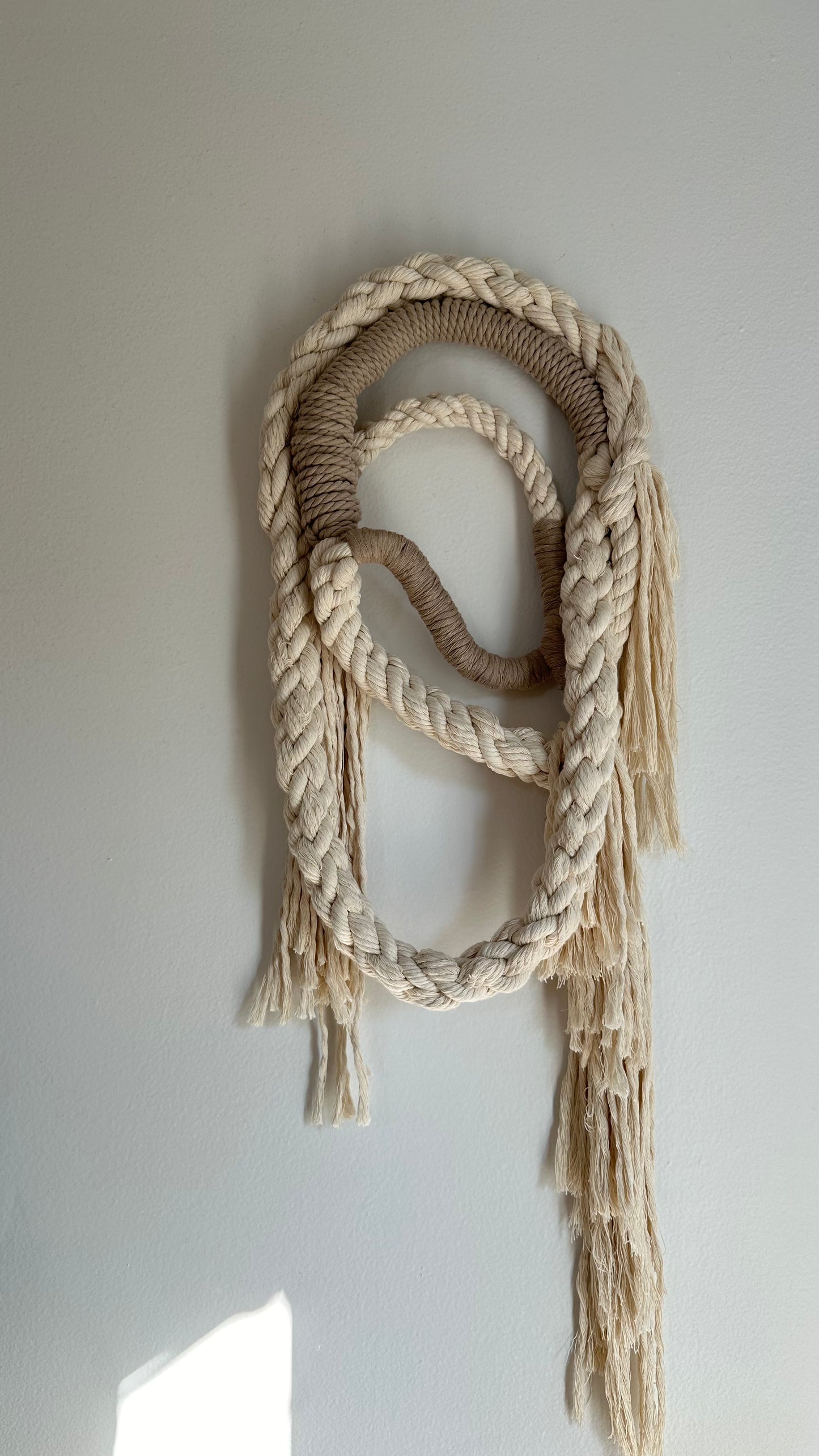 Wall Hanging made of natural colored and tan rope.