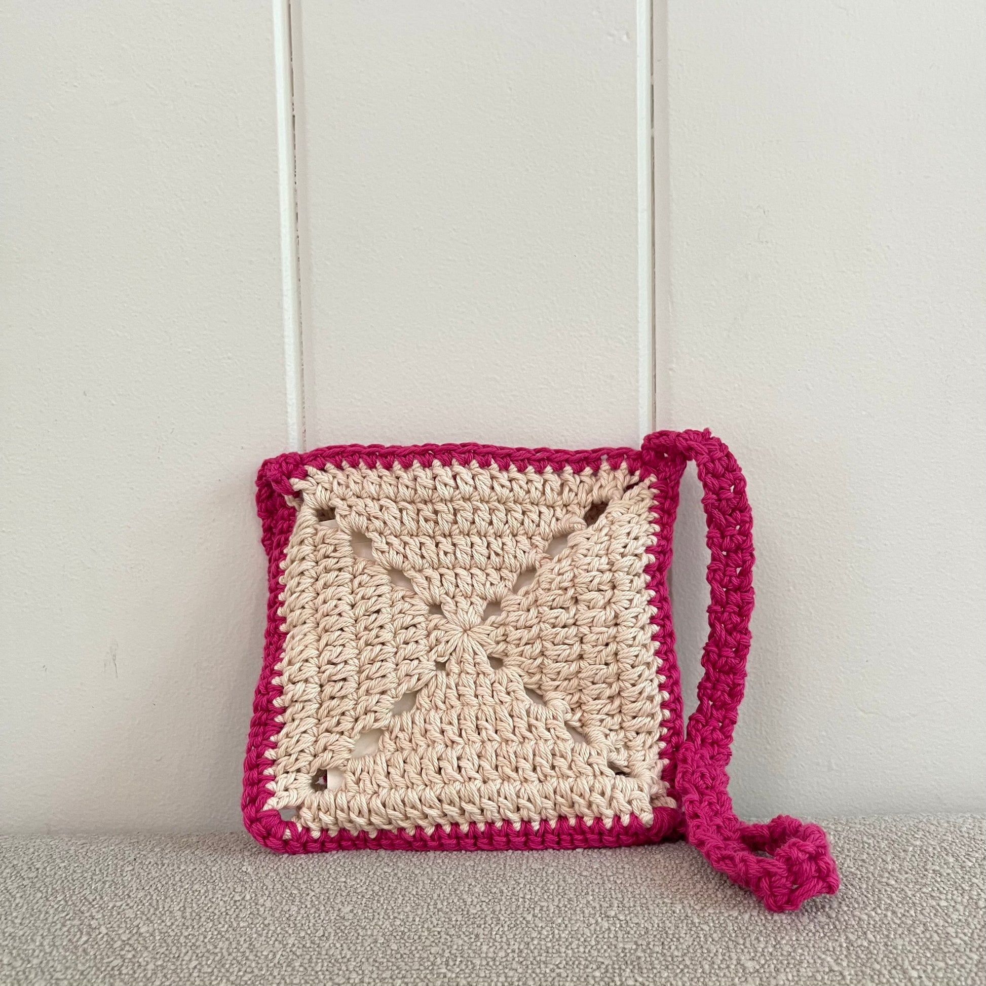 crossbody bag in pink and white. 