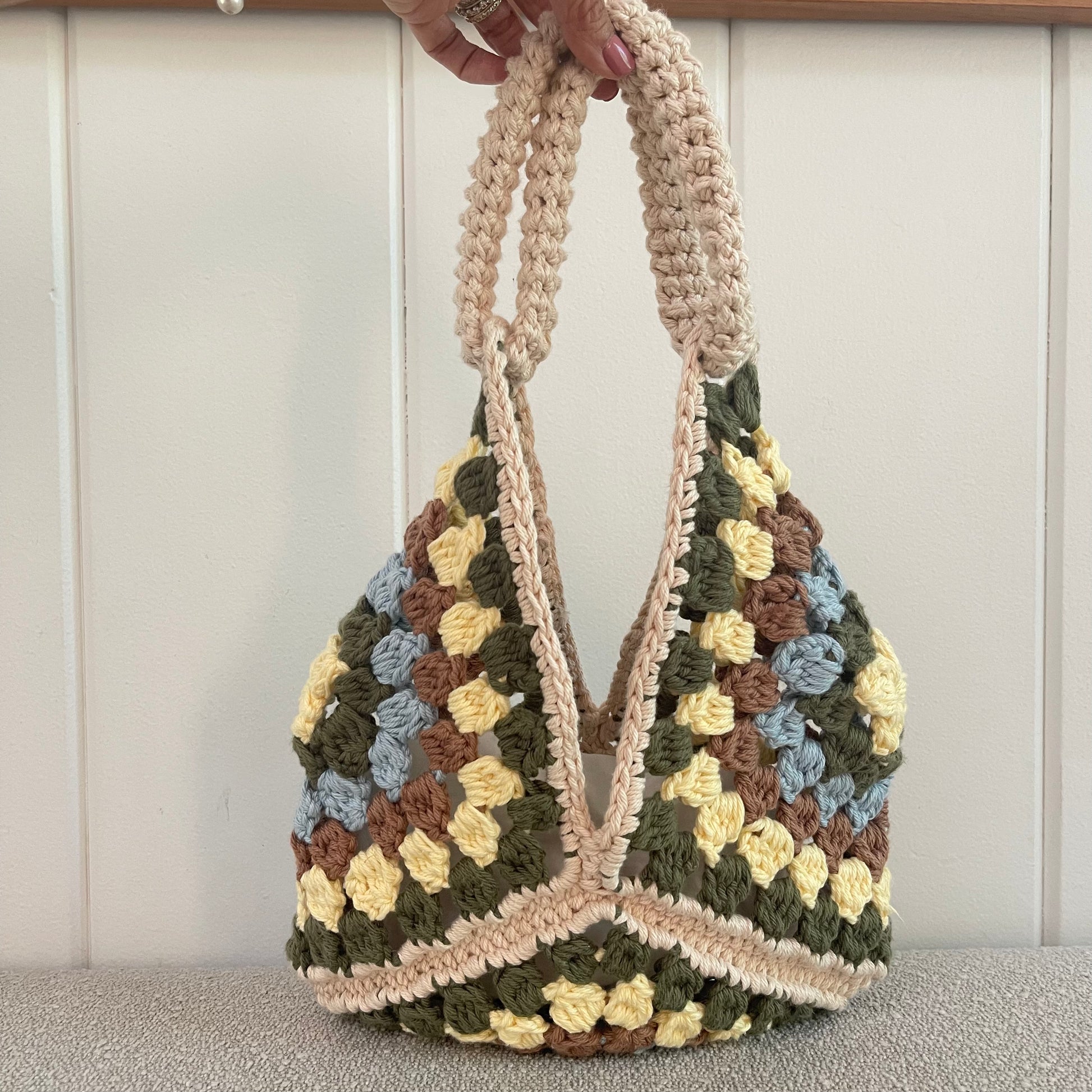 Crochet Granny Square handbag in light yellow, green, baby blue, brown and cream. 
