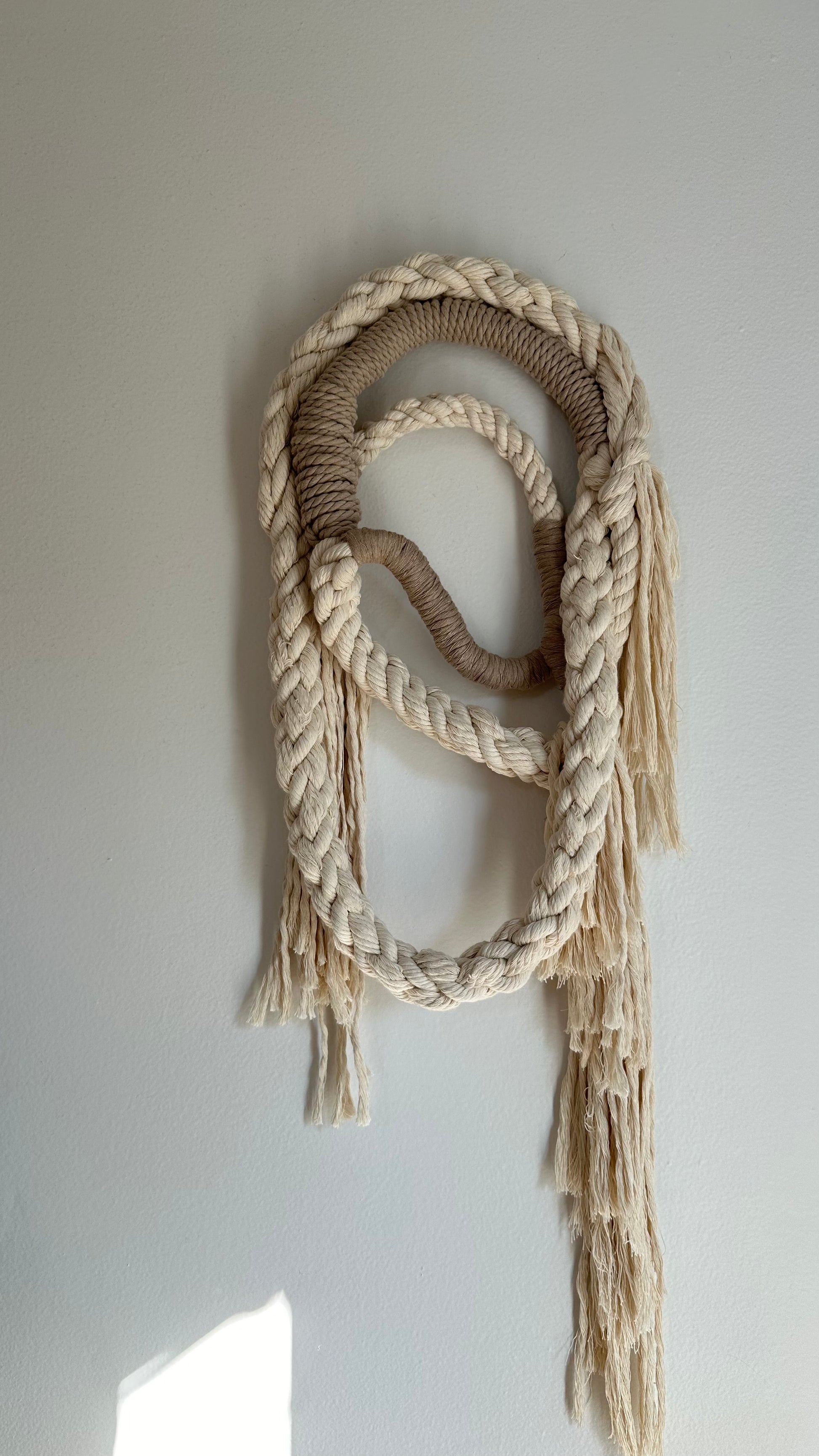 Wall Hanging made of natural colored and tan rope. 