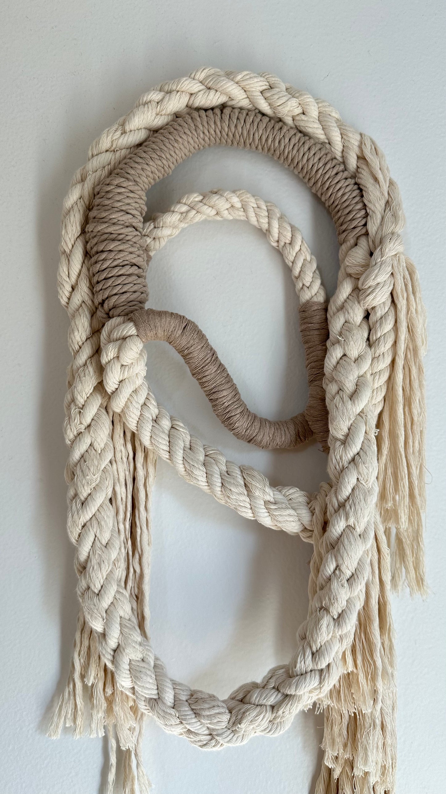 Wall Hanging made of natural colored and tan rope. 