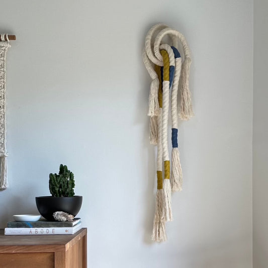 Wrapped Wall Hanging in white, blue, and yellow. 