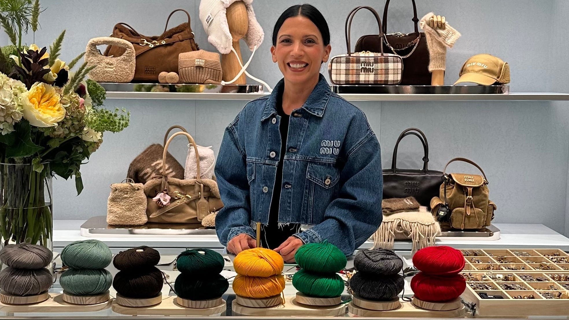 Fiber Artist standing behind a display working an event at Miu Miu