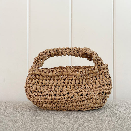 A picture of a crochet raffia handbag.   It measures 10" wide x 5" tall + a hand strap. Made of raffia.   